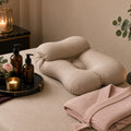 Velvet Calm Pregnancy Massage – Massage table in champagne linen with support cushion, folded blush robe, candles, oils and eucalyptus (product image, invented unbranded)