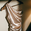 Unbranded satin one-shoulder top on a hanger (product image, invented unbranded)