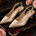 Champagne Satin Kitten-Heel Slingbacks – Champagne satin low kitten-heel slingbacks on a black lacquer tray with blush roses and burgundy ribbon (product image, invented unbranded)