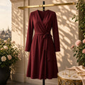 Bordeaux Bump Wrap Dress – burgundy long-sleeve wrap dress on stand, roses, London view