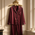 Burgundy Silk-Satin Lounge Pyjamas – burgundy satin pyjamas with cream piping on gold hanger