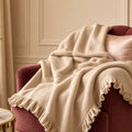 Champagne Cashmere Frill Blanket – champagne frilled knit blanket over burgundy velvet chair