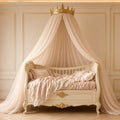 Ivory Voile Fairy-Tale Canopy Crib – ivory crib with voile canopy topped by a gold crown