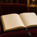 Midnight Leather Bump-to-Baby Album – open album with gilt-edged blank pages on burgundy velvet chair