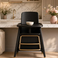 Noir Grow-With-Me Highchair – black wooden highchair with gold footrest at marble kitchen