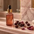 Rosehip Bump Care Oil – amber rosehip dropper oil bottle with dried rosehips on blush marble