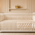 Royal Gold Satin & Lace Cot Bed Set – white cot bed with cream satin and lace bedding, gold crown on shelf above
