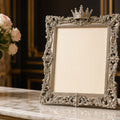 Sterling Crown Birth Record Frame – ornate silver crown-topped photo frame on marble mantel